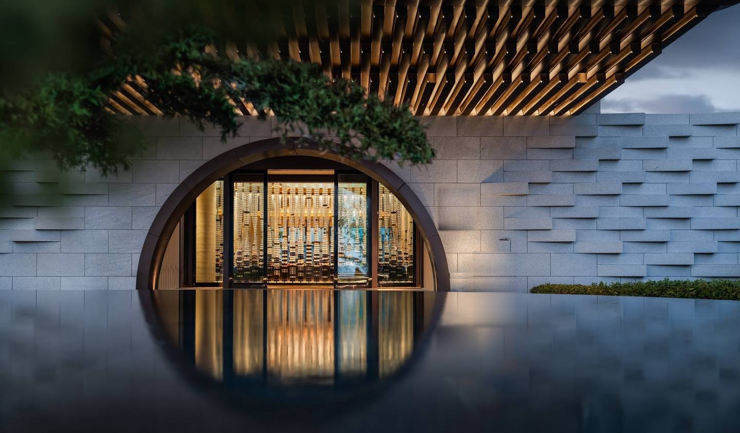 Moon-gate entrance reflected in still water