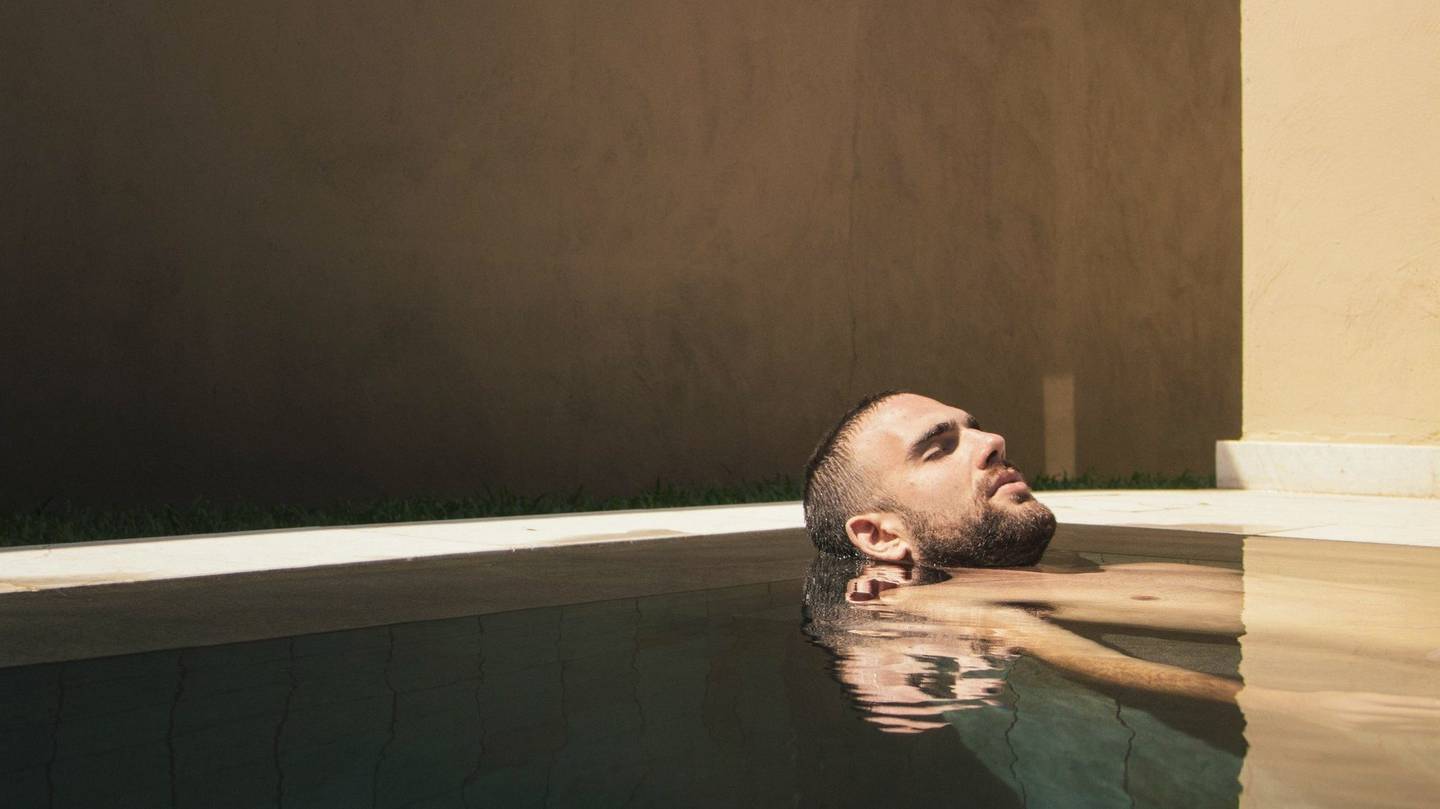 A guest relaxing in a private plunge pool